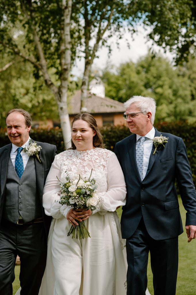 Bride walks down the aisle with fathers, Surrey Wedding Photography