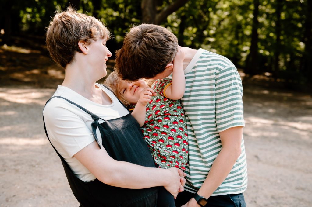 Loving family portrait in the dappled sunshine. 
