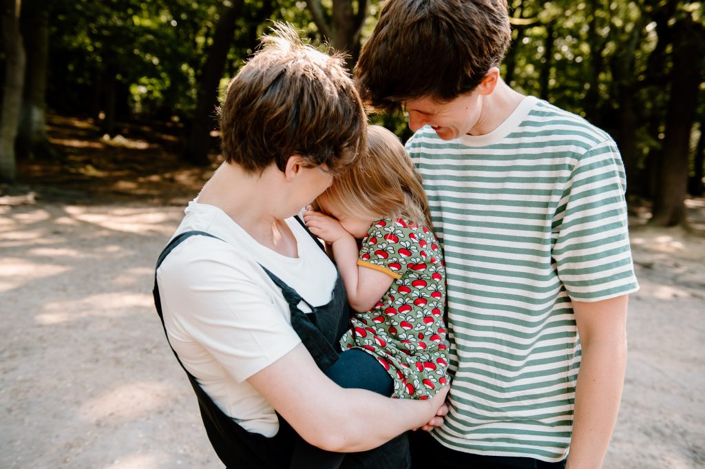 Mums snuggle into each other for relaxed family shoot. 