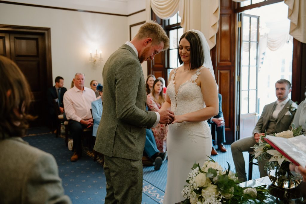 Couple Exchange Rings During Leatherhead Registry Wedding