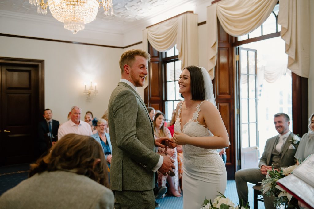 Couple Exchange Rings During Leatherhead Registry Wedding